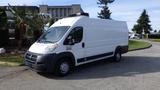 A white 2017 RAM Promaster cargo van with a roof-mounted unit parked on a driveway