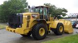 A 2019 Caterpillar 972M XE wheel loader with a large front bucket and oversized tires positioned for operation