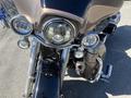 Close-up view of a 2004 Harley-Davidson FLHTCUI with chrome accents multiple headlights and sleek front fairing