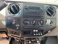 Interior view of a 2010 Ford F-550 dashboard featuring controls for air conditioning and audio system with various knobs and buttons