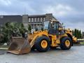 A yellow Hyundai wheel loader with a large front bucket visibly positioned for heavy lifting tasks