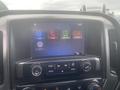 Dashboard display of a 2015 Chevrolet Silverado 3500HD showing audio settings phone options navigation and settings menu