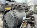 Close-up of the engine air intake system of a 2008 Hino 268 with a black plastic housing and attached tubing