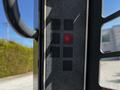 Close-up of a display panel from a 2017 Gehl R105 featuring illuminated warning lights with a red light indicating a potential issue