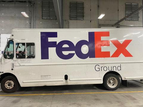 A 2010 Freightliner MT45 delivery truck with a white exterior featuring the FedEx Ground logo in large purple and red letters