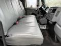 Interior of a 2007 International 4200 featuring gray leather seats with seatbelts and a driver's side dashboard with controls and a steering wheel