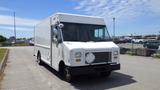 A white 2011 Ford Econoline cargo van with a flat front and large windows parked on a paved surface