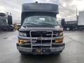 A 2018 Chevrolet Express bus with a distinctive front grille featuring the Chevrolet emblem and a metal bumper guard