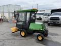 1994 John Deere F1145 lawn mower with a cab and a snow plow attachment in green and yellow colors