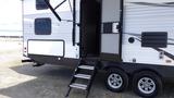 A 2021 Forest River 312BH East To West Della Terra travel trailer featuring a front door with steps leading up to it