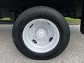 A close-up view of a white alloy wheel with a large black tire marked with the size 245/70 R19.5 and brand lettering