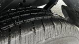 Close-up of a wet tire tread from a 2016 Nissan Frontier showing deep grooves and textured surface designed for traction