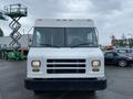 A 2005 Freightliner MT45 Chassis with a white exterior featuring a flat front and large windshield two headlights and a simple grille design