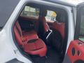 Interior view of a 2020 Land Rover Range Rover Sport showcasing red leather seats in the back row with a center console and door panel details