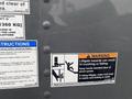 A 2018 Hino 308 vehicle with safety and operating instructions including warnings about liftgate hazards and pinch points