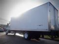 A 2013 Hino 308 box truck with a white exterior and large cargo area viewed from the side showing the wheels and part of the front cab