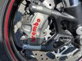 Close-up of a Brembo brake caliper on a 2018 Triumph Street Triple RS showcasing the metallic gray finish with red lettering