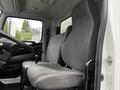 Interior view of a 2020 Hino 338 truck showing two gray upholstered seats and a black steering wheel in the driver's cabin