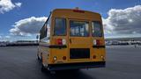 2014 Freightliner Thomas Bus Diesel with a yellow exterior and rear emergency door visible