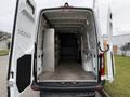A 2019 Mercedes-Benz Sprinter van with open rear doors revealing an empty cargo area featuring walls with metal support panels and a smooth floor