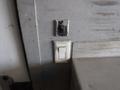 An electrical outlet and a light switch mounted on a wall inside a 2010 Forest River Enclosed trailer