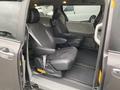 Interior view of a 2013 Toyota Sienna showing two black leather front seats and an empty space for a third seat in a minivan configuration