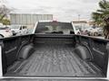 A 2018 Ford F-150 truck bed view showing a clean and empty black liner interior with raised wheel wells