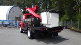 A red 2010 International 4400 truck with a black utility body equipped with a crane and a white cargo box mounted on the back