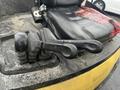 Levers of a Hyster 120 forklift with a black seat in the background