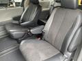 A 2013 Toyota Sienna with two front seats featuring fabric upholstery in black and gray tones and adjustable headrests