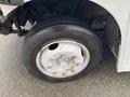 Close-up of a black tire mounted on a silver alloy wheel with visible lug nuts on a 2005 Freightliner MT45 Chassis