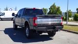 A black 2017 Ford F-350 Super Duty parked with its rear view visible showcasing a chrome tailgate and the Super Duty emblem