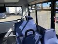 Interior view of a 2017 Chevrolet Express with blue upholstered seats and a spacious passenger area