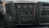 Dashboard of a 2005 Chevrolet Express displaying climate controls and audio system with a digital clock showing 1127