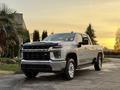 A 2023 Chevrolet Silverado 3500HD parked with a chrome grille and prominent wheel arches showcasing its robust design and modern features