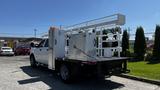 A 2019 RAM 3500 truck with a flatbed and mounted equipment including utility boxes and a lift platform at the rear