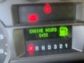 The dashboard display of a 2008 Ford F-450 SD showing engine hours at 5455 with warning lights for brake and fuel