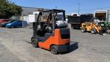 A 2018 Toyota 8FGCU25 forklift with a black and orange chassis and a propane tank mounted on the rear