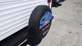 A spare tire cover displaying the logo "SMP RV" in bold blue and red letters on a black background