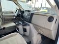 Interior view of a 2012 Ford Econoline showing the dashboard and center console with cup holders and controls