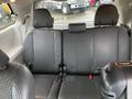 Interior view of a 2013 Toyota Sienna showcasing the black leather back seats with seat belts visible