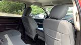 Interior view of a 2013 RAM 2500 showing the back seats and center console with gray upholstery