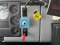 Interior dashboard controls of a 1994 Freightliner FL80 featuring gauges for fuel and transmission along with a blue switch and a red parking brake lever