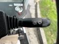 Close-up of a control lever on a 2007 Tennant Sentinel with symbols for water spray and a switch mechanism
