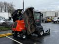 A 2020 Jacobsen HR800 turf maintenance machine with a bright orange and black exterior is shown with its deck raised revealing the blades and inner mechanics