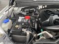 A 2017 Ford F-150 engine compartment showcasing the battery with cables connected and various components including a coolant reservoir and wiring harnesses