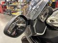 Close-up of a 2013 BMW K1600GTL motorcycle featuring a sleek design with a large windshield and side mirror showcasing intricate details of the bike's controls and dashboard