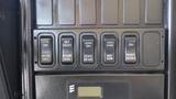 Control panel of a 2014 International 3000 with various switches for cruise control and other functions