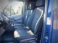 Interior view of a 2017 Mercedes-Benz Sprinter showing two front seats with fabric upholstery and a steering wheel visible