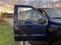 A blue 2008 Ford F-250 SD with the driver's door open showcasing the interior and dashboard